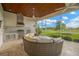 Covered patio with outdoor kitchen and comfortable seating area at 10509 Broadland Pass, Thonotosassa, FL 33592