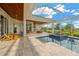 Spacious pool area with spa, outdoor kitchen, and covered seating at 10509 Broadland Pass, Thonotosassa, FL 33592