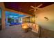 A covered patio features a pool, hot tub, and comfortable seating area with a fire pit at 10509 Broadland Pass, Thonotosassa, FL 33592