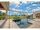 Enclosed pool area with hot tub has beautiful views of the open fields at 10509 Broadland Pass, Thonotosassa, FL 33592