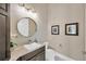 Cozy powder room with a modern vanity and decorative mirror at 10509 Broadland Pass, Thonotosassa, FL 33592