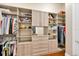 Spacious walk-in closet with custom shelving and ample storage for clothes and accessories at 10509 Broadland Pass, Thonotosassa, FL 33592