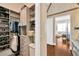 Functional walk-in closet with modern shelving; access to bedroom with stylish hardwood floors at 10509 Broadland Pass, Thonotosassa, FL 33592