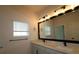 Bathroom featuring double sinks, modern lighting, and fixtures with a large mirror at 10708 Oak Bend Dr, Parrish, FL 34219