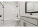 A bright bathroom features white tile shower, vanity, and a matching toilet at 10708 Oak Bend Dr, Parrish, FL 34219