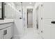 Modern bathroom with marble floors, glass shower and white cabinets at 10708 Oak Bend Dr, Parrish, FL 34219