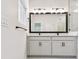 Modern bathroom featuring dual sinks, a large mirror and natural light at 10708 Oak Bend Dr, Parrish, FL 34219