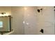 Bathroom featuring marble-style shower, glass door, and modern vanity with a sleek black fixture at 10708 Oak Bend Dr, Parrish, FL 34219