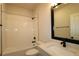 Bathroom features white subway tiles, shower and tub combo, with black fixtures and light countertop at 10708 Oak Bend Dr, Parrish, FL 34219