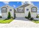 Charming townhouse exteriors showcasing gray and tan color schemes with inviting paved driveways and manicured lawns at 10708 Oak Bend Dr, Parrish, FL 34219