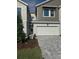 Two-story townhome featuring a brick paver driveway and attached one car garage at 10708 Oak Bend Dr, Parrish, FL 34219