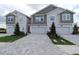 Two-story townhome featuring a brick paver driveway and attached one car garage at 10708 Oak Bend Dr, Parrish, FL 34219
