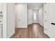 Entry hallway featuring modern wood-look flooring and neutral walls, leading to the main living areas at 10708 Oak Bend Dr, Parrish, FL 34219