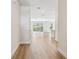 Bright hallway boasts wood-look floors leading to an open living area with sliding glass doors to the outside at 10708 Oak Bend Dr, Parrish, FL 34219