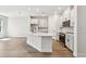 Bright kitchen features white cabinets, stainless steel appliances, and a large center island at 10708 Oak Bend Dr, Parrish, FL 34219