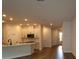 Bright kitchen with stainless steel appliances, white cabinets, and an island with a sink at 10708 Oak Bend Dr, Parrish, FL 34219