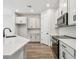 Well-lit kitchen with white cabinets, stainless appliances, and quartz countertops at 10708 Oak Bend Dr, Parrish, FL 34219