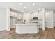 Bright kitchen with white cabinets, modern appliances, and a large center island with quartz countertops at 10708 Oak Bend Dr, Parrish, FL 34219