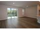 Spacious living room with wood floors and sliding glass doors leading to the outside at 10708 Oak Bend Dr, Parrish, FL 34219
