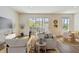 Open-concept living room with modern decor, natural light, and sliding door access to patio at 10708 Oak Bend Dr, Parrish, FL 34219