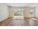 Bright and open living room featuring wood floors and sliding glass doors to bring the outdoors in at 10708 Oak Bend Dr, Parrish, FL 34219