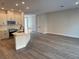 Open-concept living space featuring a kitchen island and hardwood style floors at 10708 Oak Bend Dr, Parrish, FL 34219