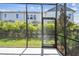A screened-in lanai offers an ideal outdoor space with views of the yard and landscaping at 10708 Oak Bend Dr, Parrish, FL 34219