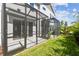 A screened patio with a view of the landscaped backyard at 10708 Oak Bend Dr, Parrish, FL 34219