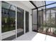 Large screened patio featuring access to the yard, with doors for natural light and outdoor enjoyment at 10708 Oak Bend Dr, Parrish, FL 34219