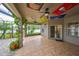 Spacious covered patio with tile flooring offering shade and great backyard views at 10916 Dunscore Cottage Way, Wimauma, FL 33598