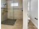 Bathroom featuring tile shower with glass door and mosaic floor at 11443 Apple Tree Cir, Bradenton, FL 34211