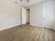 Bright bedroom with light-toned vinyl floors, paneled doors, and ceiling fan at 11443 Apple Tree Cir, Bradenton, FL 34211