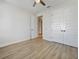 Bright bedroom with light-toned vinyl floors, paneled doors, and ceiling fan at 11443 Apple Tree Cir, Bradenton, FL 34211