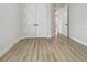 Bright bedroom with light-toned vinyl floors and closet with paneled doors at 11443 Apple Tree Cir, Bradenton, FL 34211