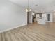 Spacious dining area with views to the kitchen which is equipped with white cabinetry and stainless steel appliances at 11443 Apple Tree Cir, Bradenton, FL 34211