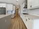 Modern kitchen featuring stainless steel appliances and sleek white cabinets, offering a clean, contemporary look at 11443 Apple Tree Cir, Bradenton, FL 34211