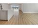 Bright, modern kitchen island area flows into an open living area and features wood floors at 11443 Apple Tree Cir, Bradenton, FL 34211