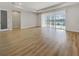 Bright and open living area features wood floors and sliding glass doors overlooking the pool at 11443 Apple Tree Cir, Bradenton, FL 34211