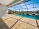 Relaxing screened-in pool and patio area with a tranquil water view, perfect for outdoor living at 11443 Apple Tree Cir, Bradenton, FL 34211
