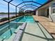 Private in-ground pool and spa with screened enclosure and tranquil lake view at 11443 Apple Tree Cir, Bradenton, FL 34211