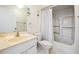 Bathroom featuring a combined tub and shower, single sink vanity, and white ceramic tiling at 11450 Harbor Way # 5008, Largo, FL 33774