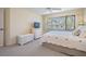 Cozy bedroom with large window, dresser, and chest adding storage and classic charm to the space at 11450 Harbor Way # 5008, Largo, FL 33774