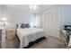 Bedroom featuring a spacious closet and a ceiling fan above a bed with decorative pillows and matching lamps at 11450 Harbor Way # 5008, Largo, FL 33774