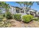 Inviting condo building with mature landscaping and a cozy front entrance at 11450 Harbor Way # 5008, Largo, FL 33774