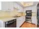 Efficient kitchen layout with black dishwasher, stainless appliances and white cabinets at 11450 Harbor Way # 5008, Largo, FL 33774