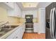Well-lit kitchen featuring stainless steel appliances and white cabinetry at 11450 Harbor Way # 5008, Largo, FL 33774