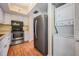Galley kitchen with stainless appliances, stacked laundry and white cabinets at 11450 Harbor Way # 5008, Largo, FL 33774