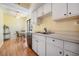 Bright kitchen with white cabinets, stainless steel sink, and breakfast table near window at 11450 Harbor Way # 5008, Largo, FL 33774