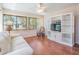 Bright living room with a white couch, wood floors, and built-in shelving at 11450 Harbor Way # 5008, Largo, FL 33774