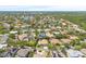 Beautiful aerial shot of a home nestled among mature trees near lakes and lush landscaping at 1220 Darlington Oak Ne Cir, St Petersburg, FL 33703